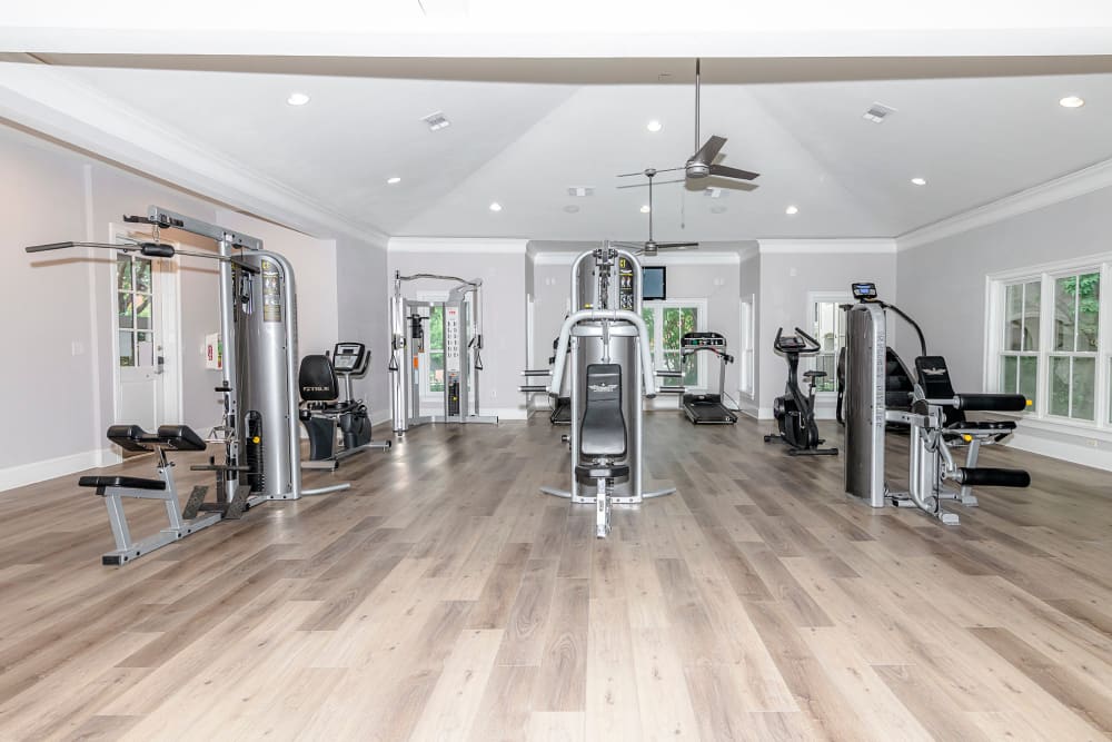 Well equipped fitness center with hardwood floors at The Lyndon in Irving, Texas