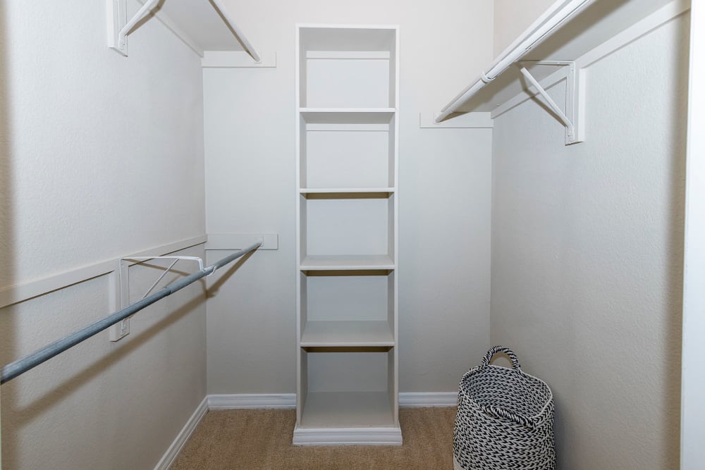 Walk in closet with woven basket hamper at The Lyndon in Irving, Texas
