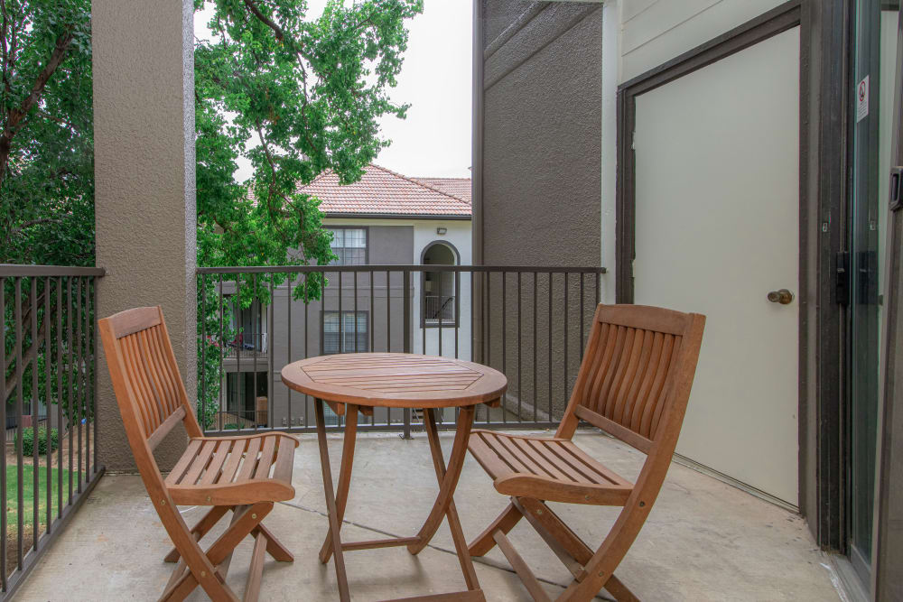 Wooden chairs on unit porch at The Lyndon in Irving, Texas