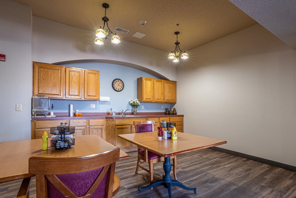 Small cafe with seating and a kitchenette at Traditions of Owatonna in Owatonna, Minnesota