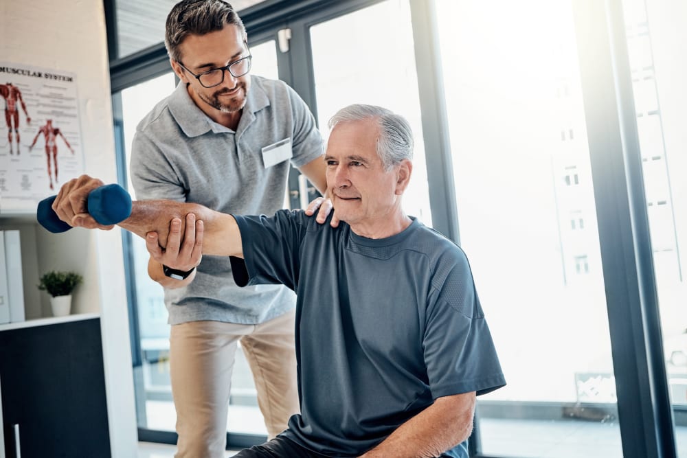 Instructor assisting a resident in strength training at Edencrest at Siena Hills in Ankeny, Iowa