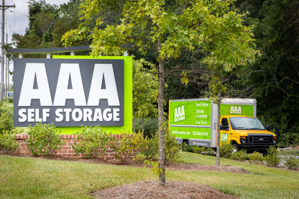 Sign and moving truck outside of AAA Self Storage at Eastchester Dr in High Point, North Carolina