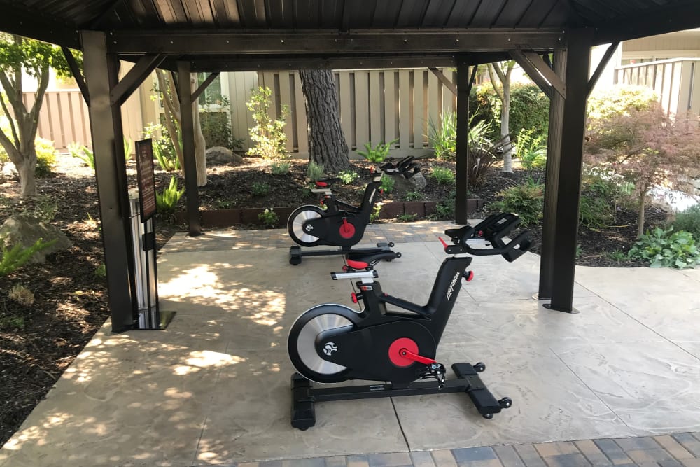 Resident using the fitness center at Halford Gardens Apartments in Santa Clara, California