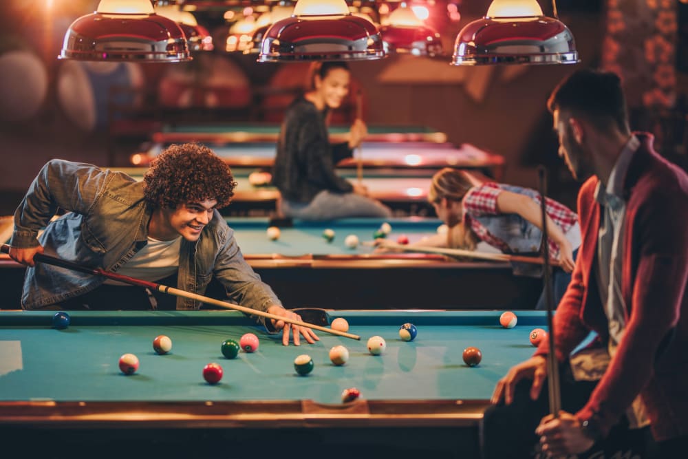 Friends playing pool near RISE at State College in State College, Pennsylvania