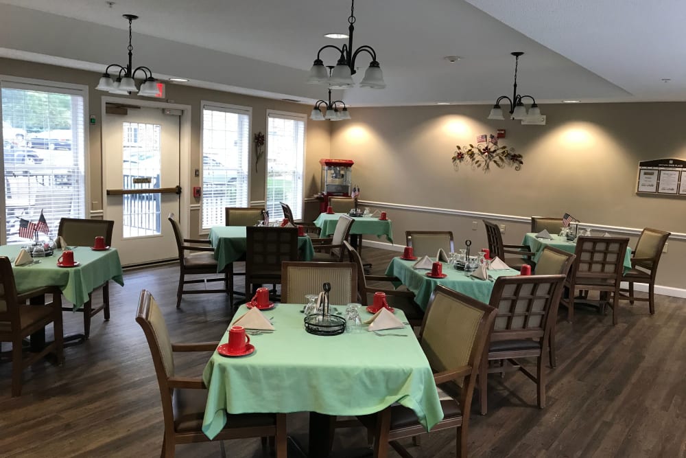 Dining room with large windows and spread-out tables at Brown Deer Place in Coralville, Iowa