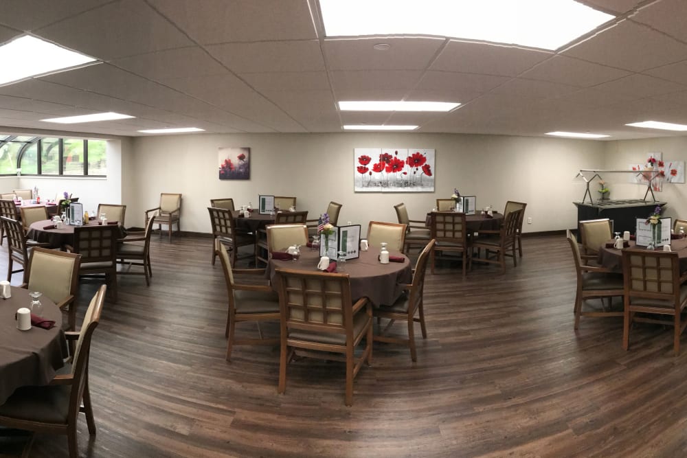 Dining room with dark hardwood floors and lots of space at Brown Deer Place in Coralville, Iowa