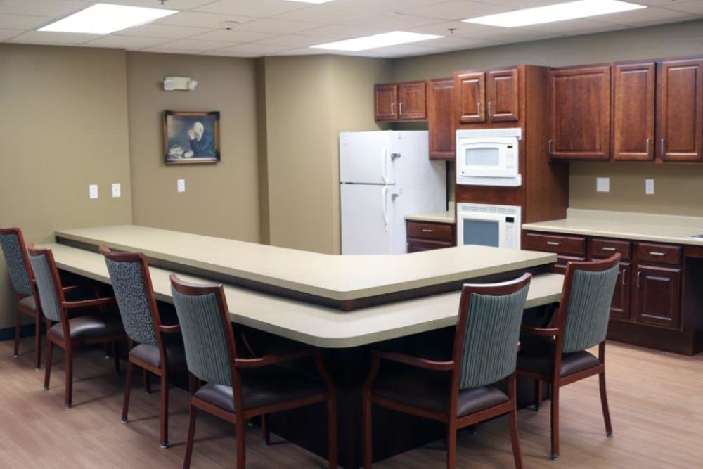 Community kitchen with a serving bar and seating at Keelson Harbour in Spirit Lake, Iowa