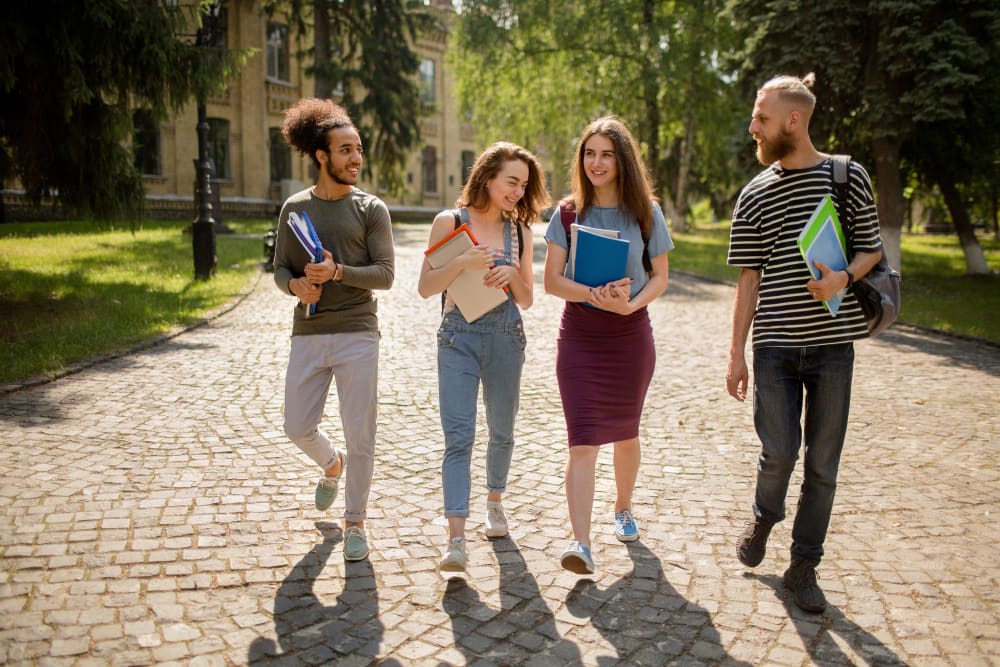 Friends walking through campus near Arc at Old Colony in Chicago, Illinois