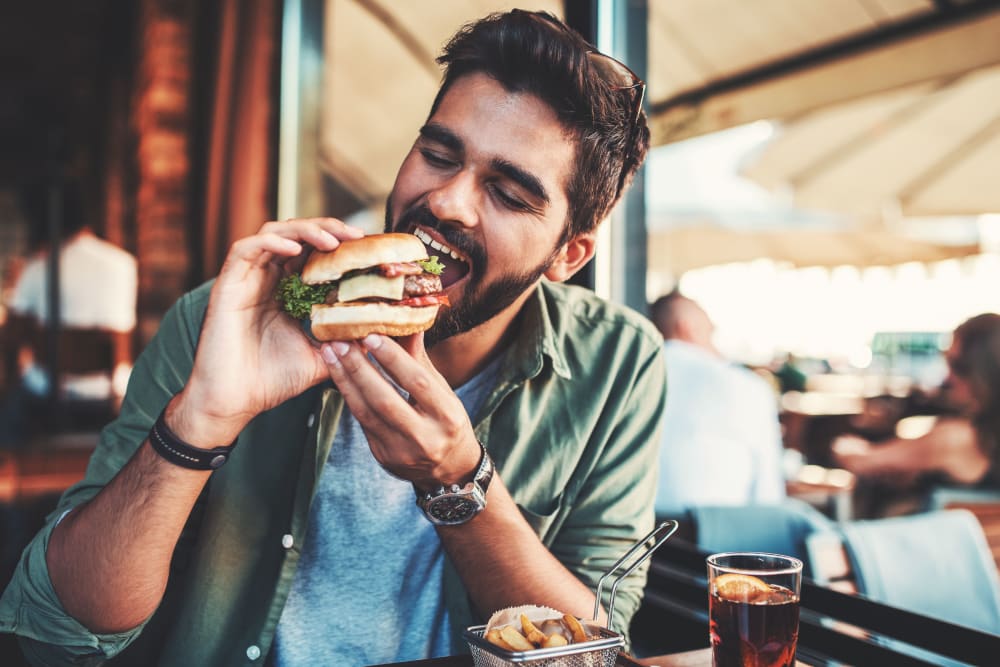 Resident enjoying a burger near Arc at Old Colony in Chicago, Illinois