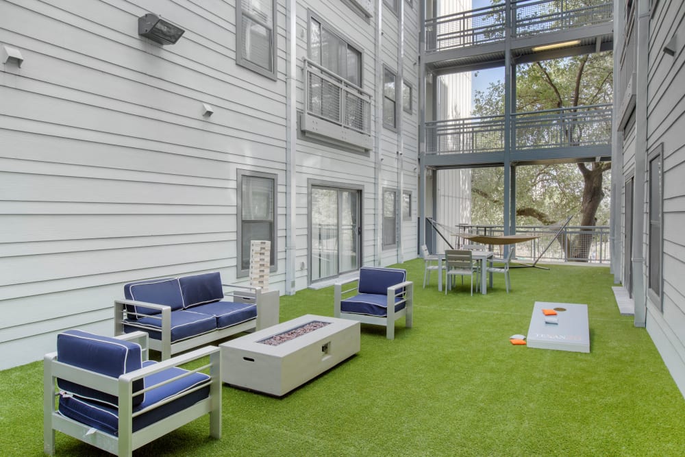 Courtyard with cornhole boards at Texan 26 in Austin, Texas