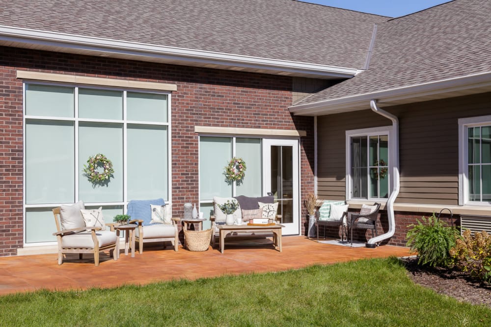 Sunlit patio seating outside Edencrest at Siena Hills in Ankeny, Iowa