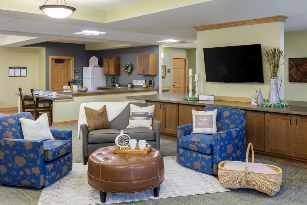 Senior lounge with a tv, snack bar, and lots of seating at Edencrest at Siena Hills in Ankeny, Iowa