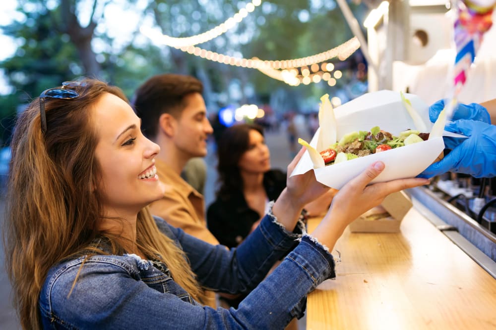 Friends getting food from a local food truck in Philadelphia, Pennsylvania near The Link University City