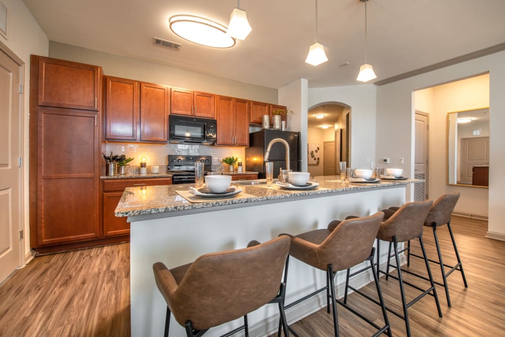 Model kitchen with dark wood at Olympus Katy Ranch in Katy, Texas