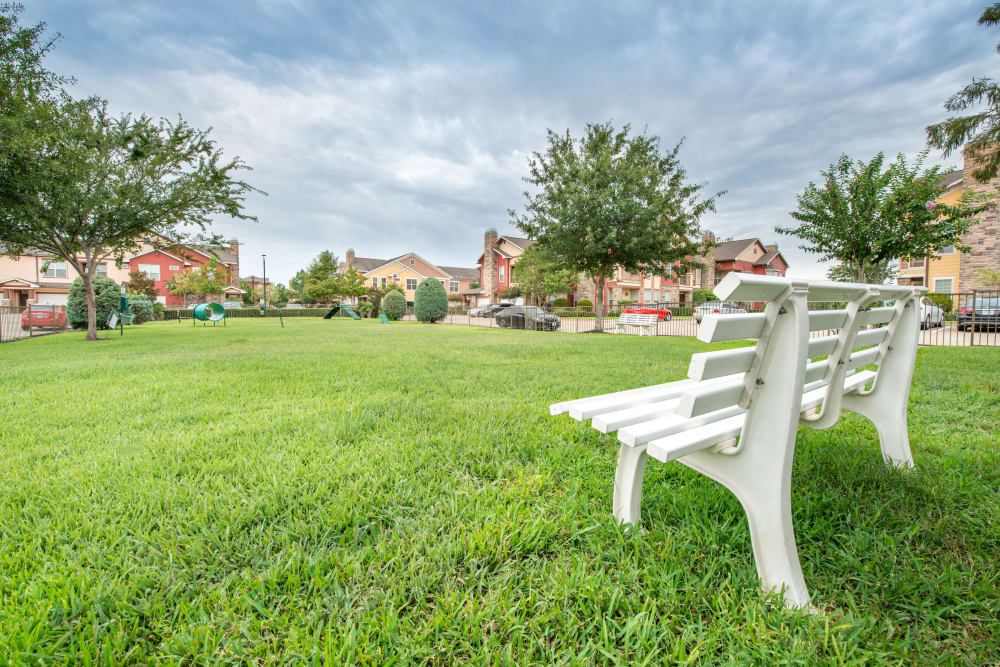 Grassy field with play equipment at Olympus Katy Ranch in Katy, TX