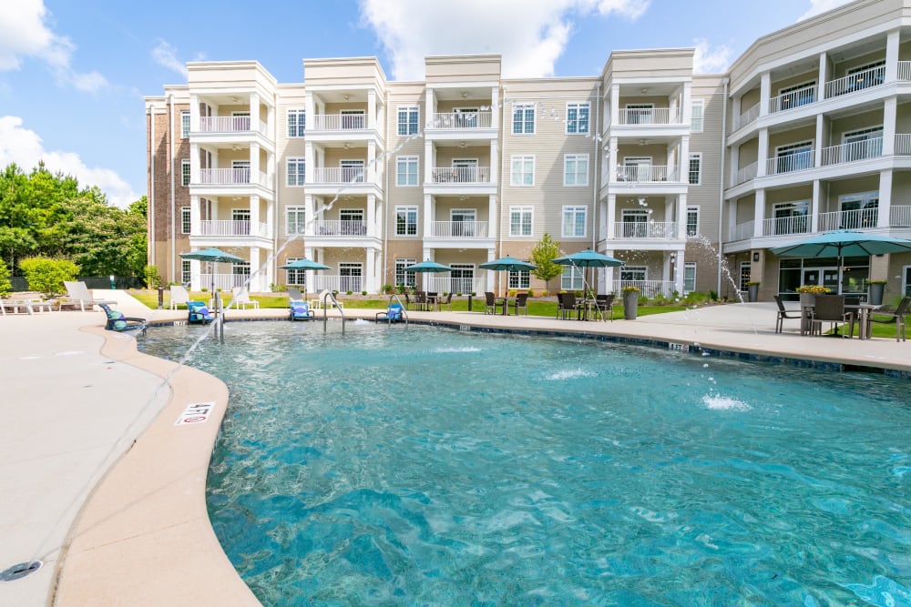 Resort-style swimming pool with fountains at The Station at River Crossing in Macon, Georgia