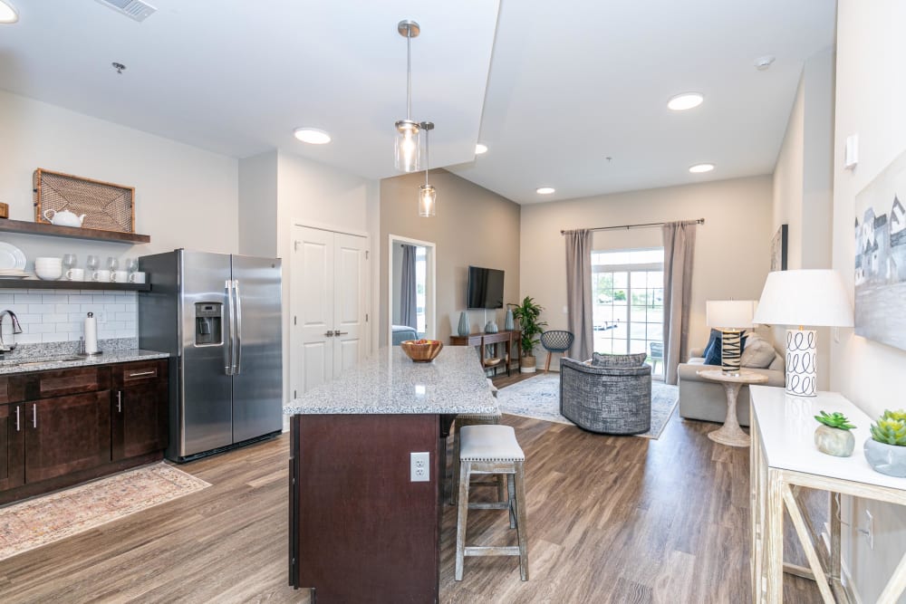 Spacious open-concept floor plan with hardwood flooring and recessed lighting in a model home at The Station at River Crossing in Macon, Georgia
