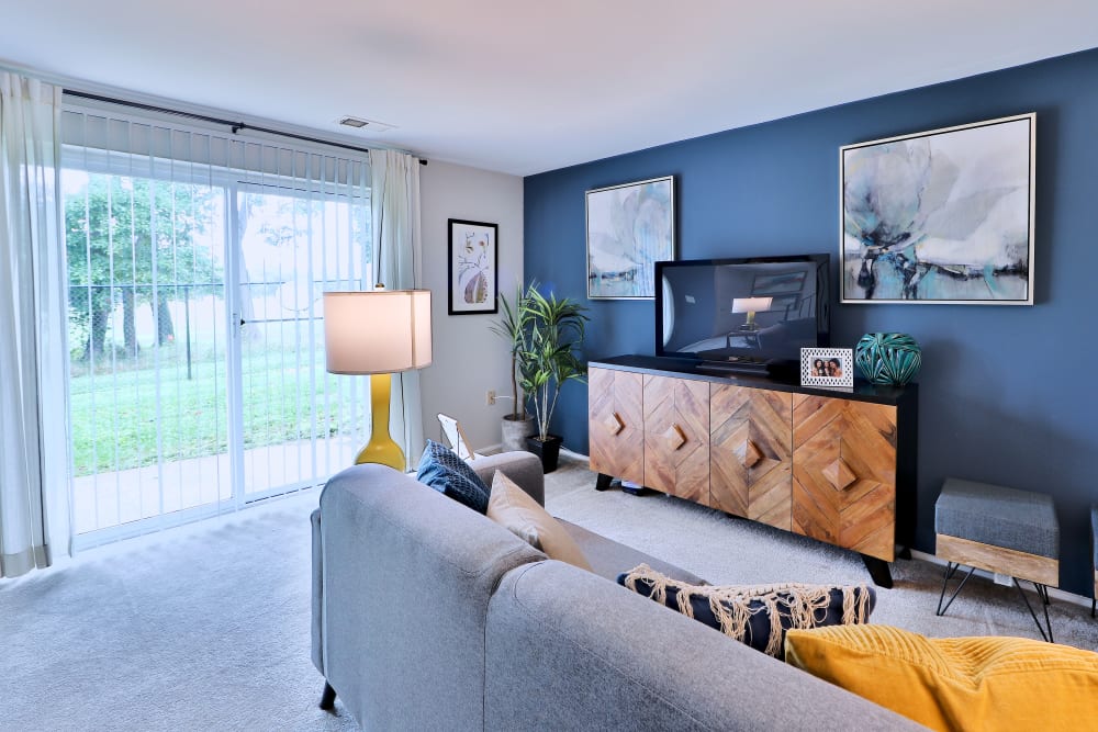 Living room opening onto a private patio at Gwynnbrook Townhomes in Baltimore, Maryland