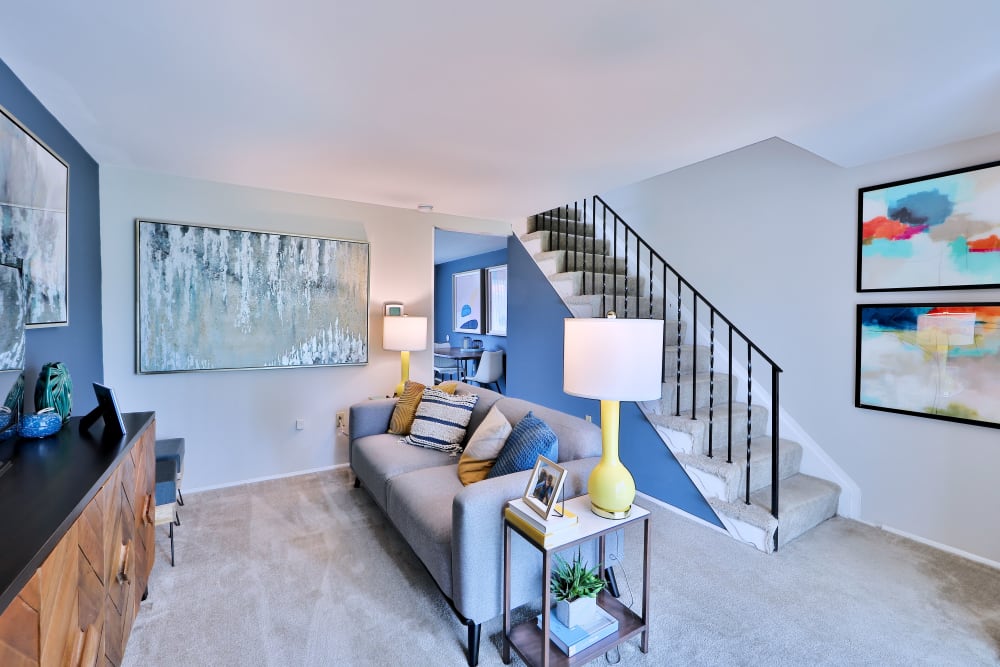 Living room with wall-to-wall carpeting at Gwynnbrook Townhomes in Baltimore, Maryland