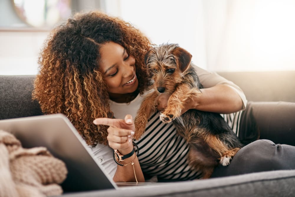 Student resident sitting with her dog at HERE Tuscaloosa in Tuscaloosa, Alabama