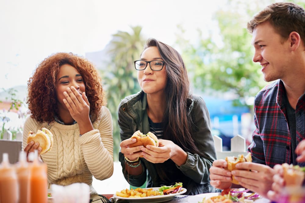 Friends eating lunch together at a local restaurant in Miami, Florida near The Cloisters