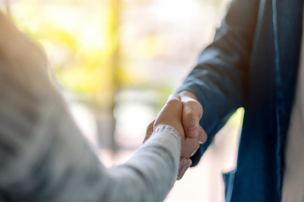 two businessmen shaking hands in Bethesda, Maryland near CAPREIT