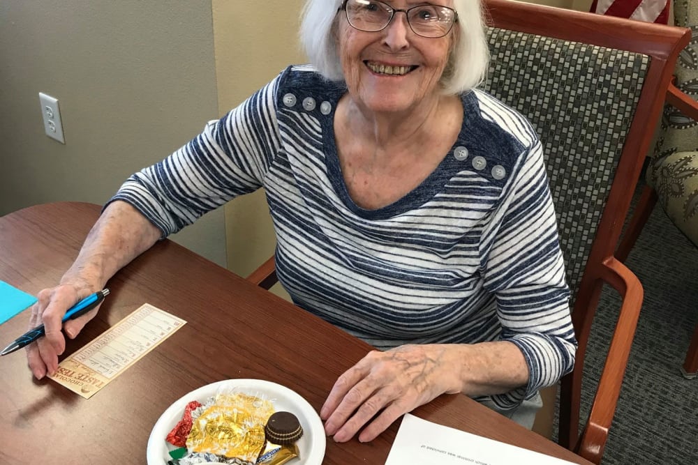 Resident participating in a chocolate taste test event at Keelson Harbour in Spirit Lake, Iowa