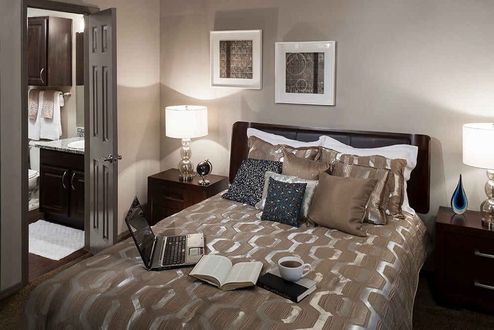 En suite bathroom in the well-furnished primary bedroom of a model home at Hyde Park at Montfort in Dallas, Texas