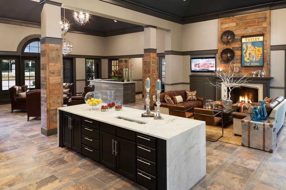 Fireplace lounge area near the demonstration kitchen in the clubhouse at Hyde Park at Montfort in Dallas, Texas