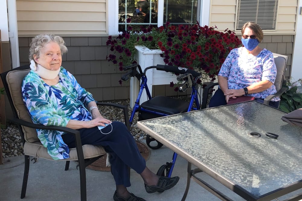 Residents sitting outside at Emery Place in Robins, Iowa