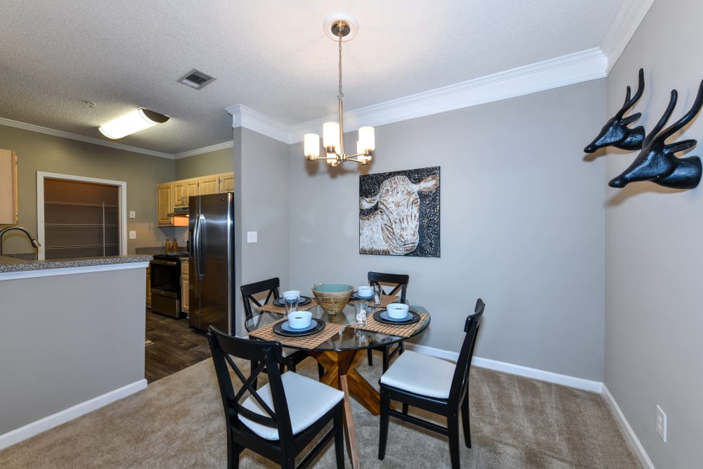 Dining area with a chandelier overhead in a model apartment at 860 South in Stockbridge, Georgia
