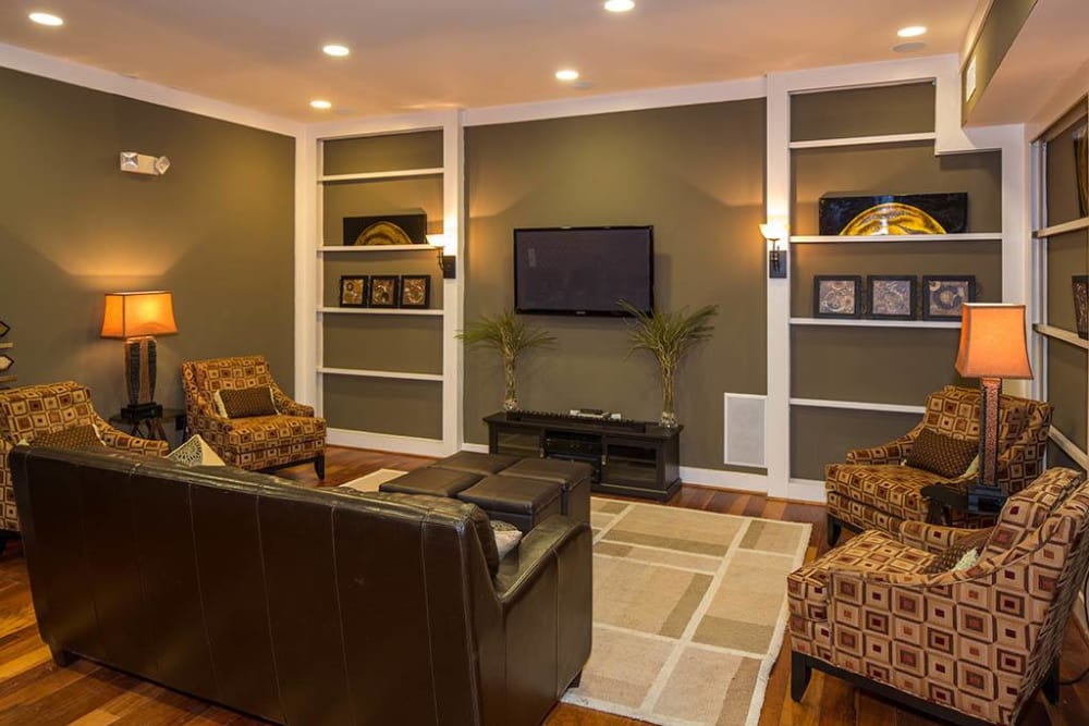 Spacious living area with classic furnishings and built-in shelving in a model apartment at The Preserve at Greison Trail in Newnan, Georgia