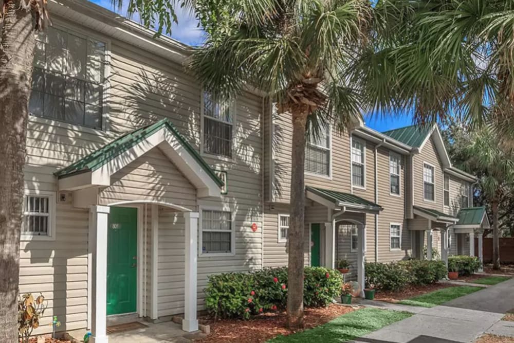 Exterior view of resident buildings and well-maintained landscaping at The Coast of Naples Florida in Naples, Florida