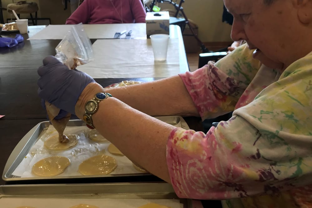 Resident creating delicious treats in a baking class at Edencrest at Green Meadows in Johnston, Iowa