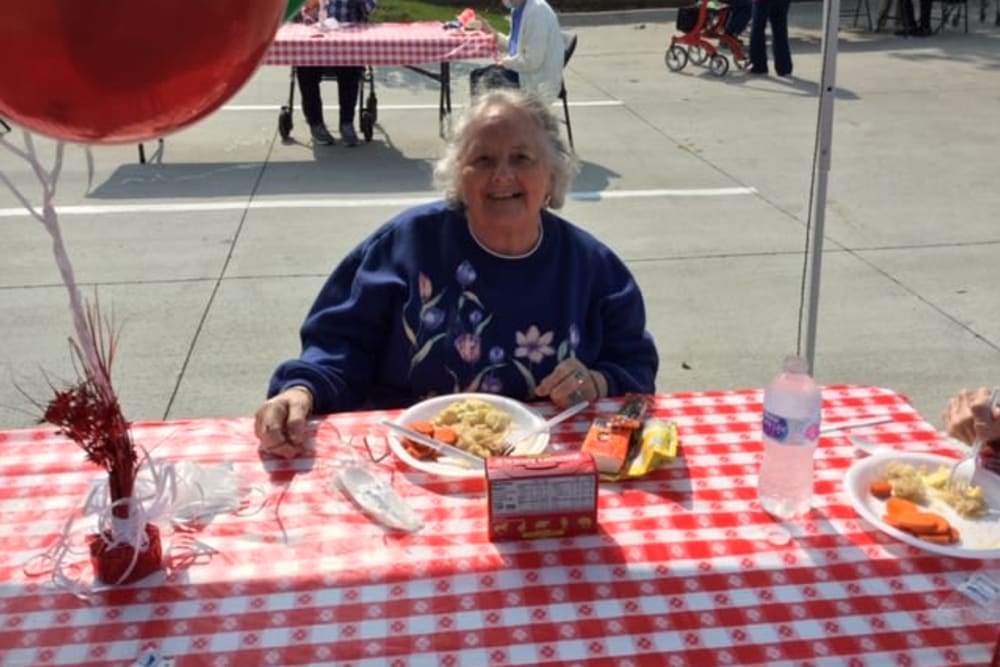 Resident eating outside at Edencrest at The Legacy in Norwalk, Iowa