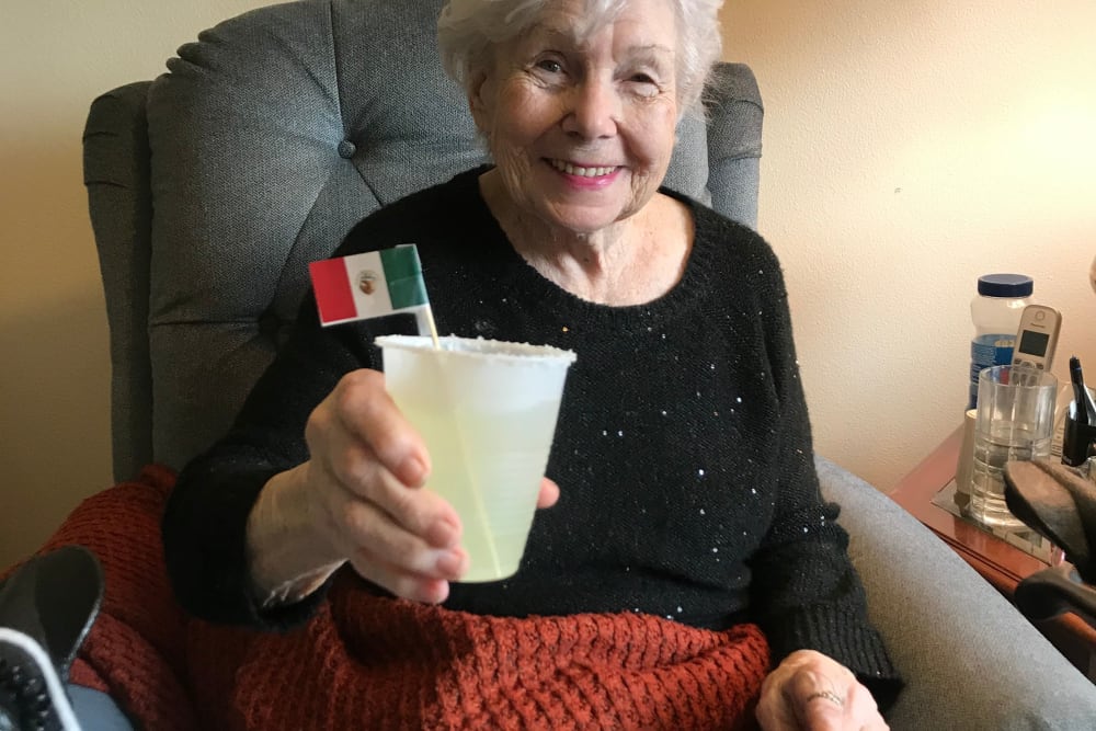 Resident enjoying a drink at Edencrest at Riverwoods in Des Moines, Iowa