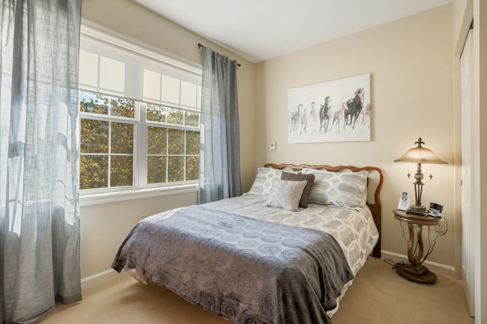 Bedroom with a large bed next to a big window at The Hearth at Franklin in Franklin, Tennessee