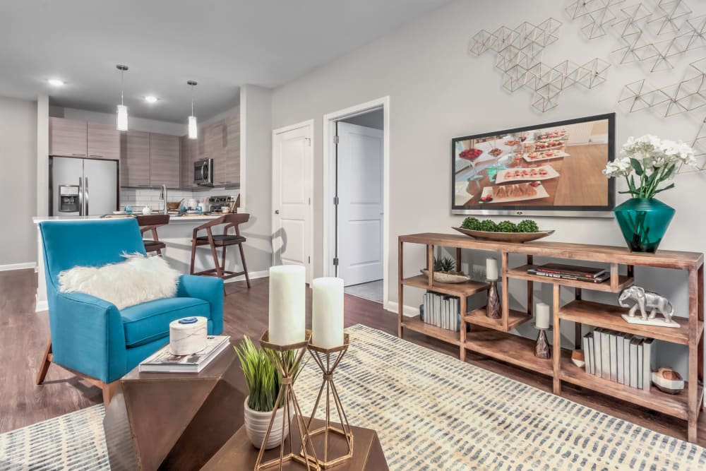 Spacious living room with wood-style flooring at The Palmer in Charlotte, North Carolina