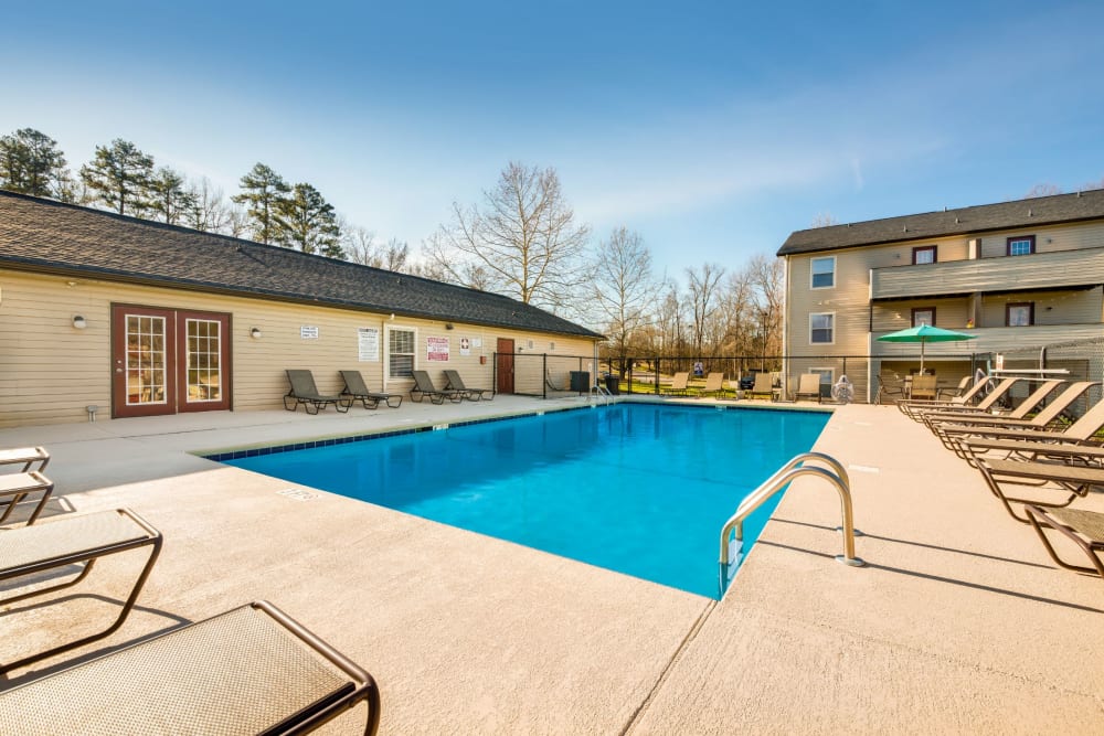 Swimming pool with a spacious sundeck at Alexander Station Apartment Homes in Salisbury, North Carolina