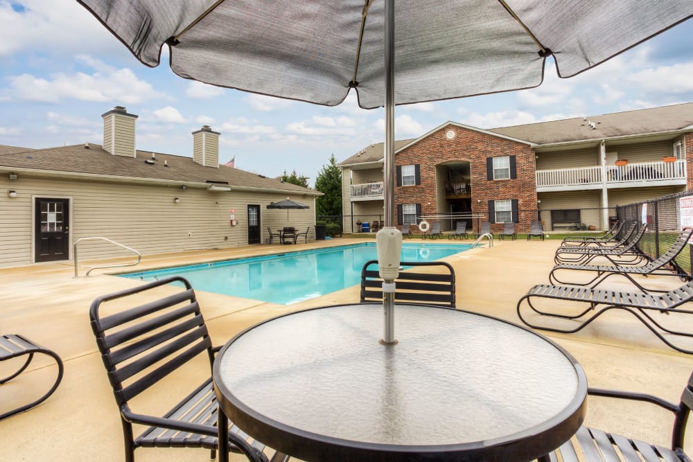 Swimming pool with a large sundeck for lounge chairs at Highland Ridge Apartment Homes in High Point, North Carolina