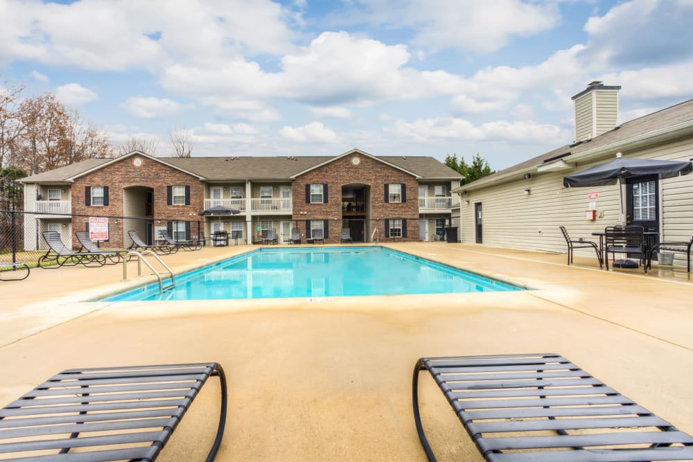 Swimming pool with a large sundeck for lounge chairs at Highland Ridge Apartment Homes in High Point, North Carolina