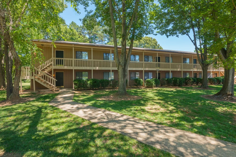 Exterior of Lakewood Apartment Homes with mature trees in Salisbury, North Carolina