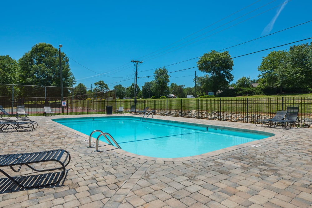 Beautiful swimming pool with lounge chairs at Lakewood Apartment Homes in Salisbury, North Carolina