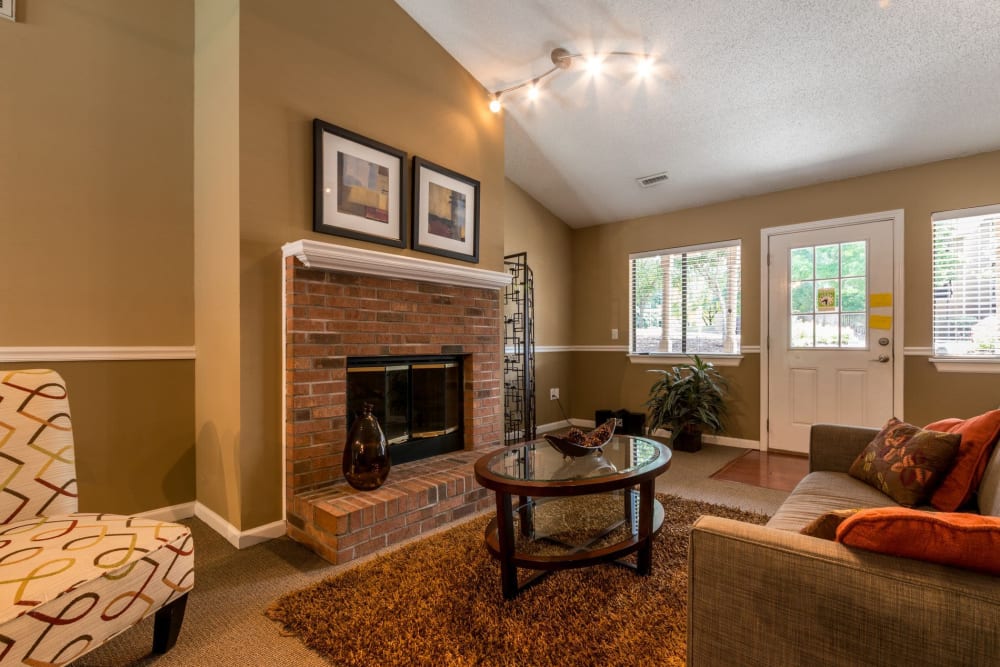 Clubhouse interior with a fireplace at Waters Edge Apartment Homes in Concord, North Carolina