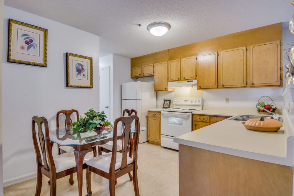 Kitchen with white appliances at Woodbrook Apartment Homes in Monroe, North Carolina