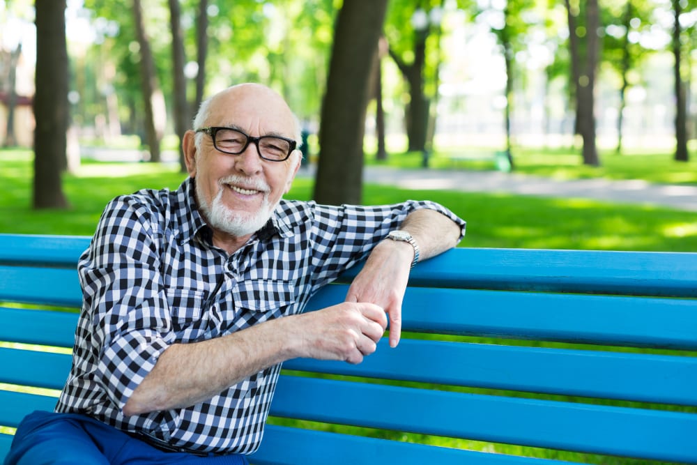 A resident on a bench near Merrill Gardens at Gilroy in Gilroy, California. 