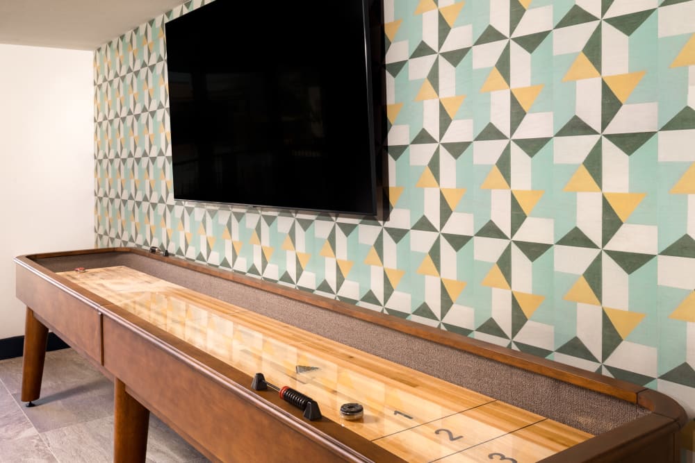 Clubhouse shuffle board and tv at Olympus on Broadway in Carrollton, TX