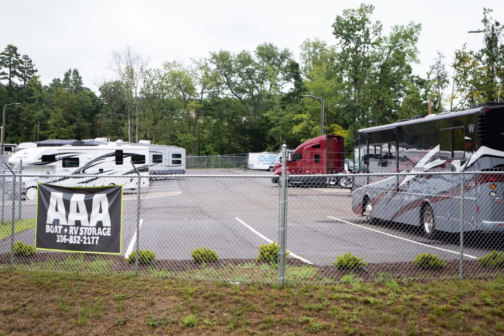 rvs stored within the fence at at AAA Self Storage Boat & RV Parking in Greensboro, North Carolina