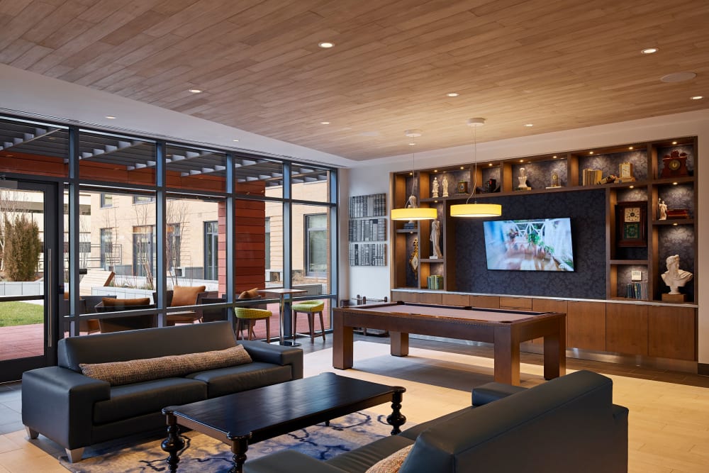 Modern clubhouse lounge with a flat-screen TV at Solaire 8250 Georgia in Silver Spring, Maryland