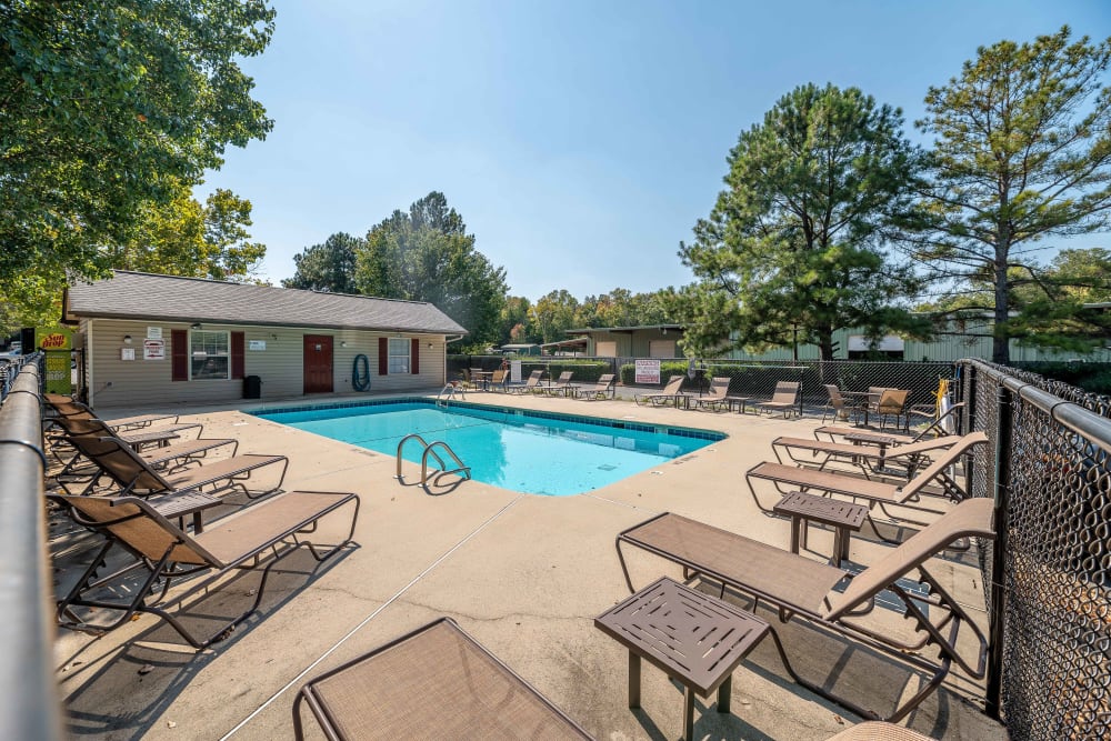 Swimming pool with a large sundeck and lounge chairs at Waters Edge Apartment Homes in Concord, North Carolina